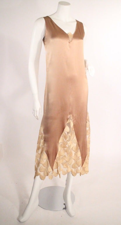 This 1930s silk slip dress is stunning. Features a beautiful champagne bronze color with a gold netted/lace scalloped bottom. The back has a gorgeous drape which falls perfectly on the right places. Very good condition.