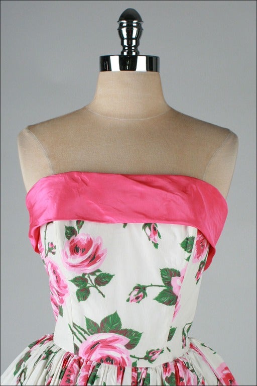vintage 1950's dress

* white acetate
* pink rose print
* dark pink trim with back bow and sashes
* strapless bodice with stays
* bubble skirt
* pellon backing
* metal back zipper

condition | excellent

fits like s/m

length