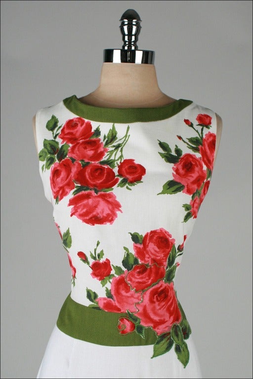 vintage 1960's dress

* similar style as worn on Mad Men's Kitty
* white linen and cotton pique 
* red/pink rose print and appliques
* green trim
* metal back zipper
* tag has been partly removed but I've had this exact dress before and can