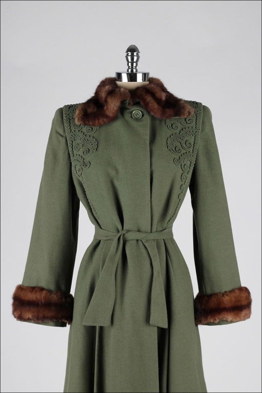 vintage 1940's coat

* green wool gabardine
* mink fur trim
* raised and rolled stitching details
* tie belt
* strong shoulders
* satin lining

condition | excellent - just a bit of fur rub/wear at back of wrists

fits like s/m

length