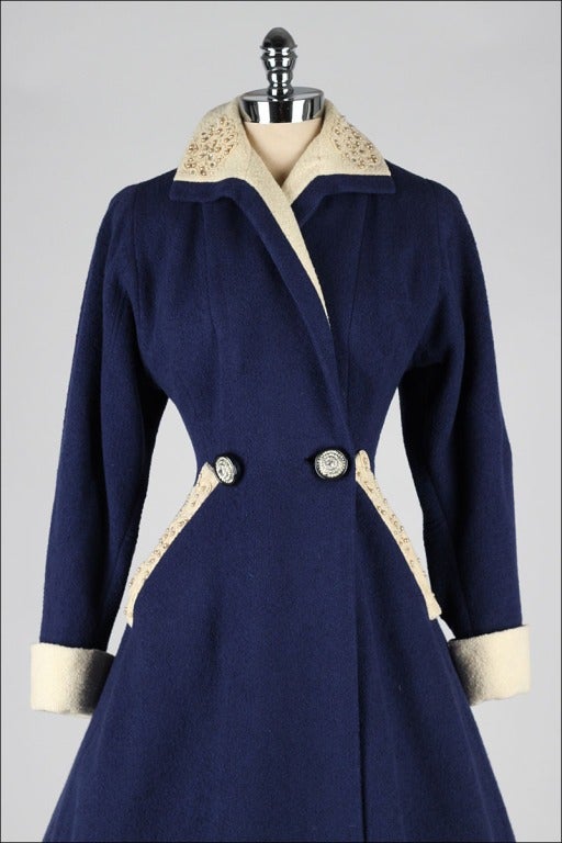 vintage 1940's coat

* blue and ivory wool boucle
* pearl and rhinestone trim
* rhinestone buttons
* fit and flare princess style
* besom pockets
* acetate lining

condition | excellent - one stone missing from button

fits like