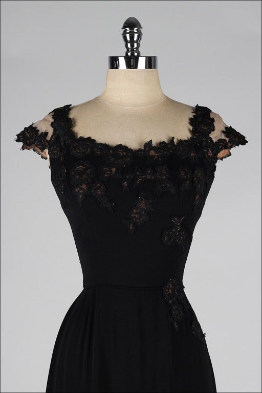 vintage 1950's dress

* black rayon crepe
* gorgeous illusion bodice and shoulders
* lace details
* acetate lining
* metal back zipper
* by Peggy Hunt

condition | excellent

fits like xs/s

length 43