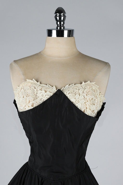 vintage 1950's dress

* black taffeta
* macrame lace bodice details
* strapless bodice with stays
* metal side zipper
* by Emma Domb

condition | excellent

fits like xs/s

length 43