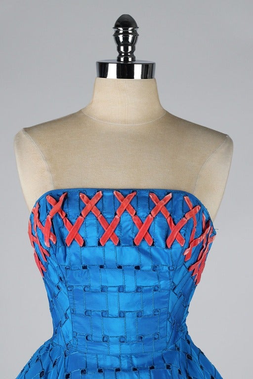 vintage 1950's dress

* cobalt blue basket weave cutout taffeta
* coral velvet ribbon woven around bust
* acetate and tulle linings
* strapless bodice with stays
* metal side zipper
* by Cotillian Formals

condition | excellent

fits like