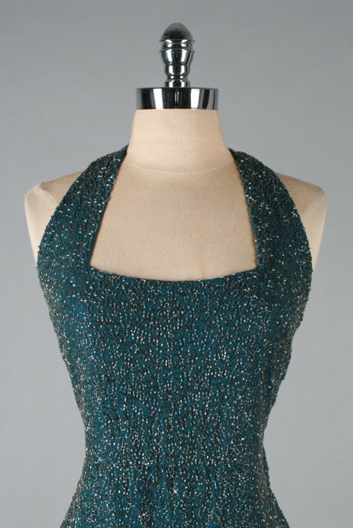 vintage 1930's gown 

* teal green silk crepe with a touch of plum iridescent color
* bodice covered in glass bugle beading
* halter strap bodice
* metal side snaps and hook/eye closure
* double kick pleats at back hem
* absolutely
