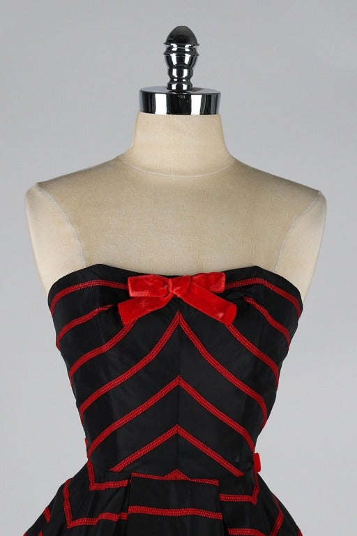 vintage 1950's dress

* black taffeta
* red embroidery
* bow details
* strapless bodice with stays
* metal back zipper
* acetate and tulle linings
* by Emma Domb

condition | perfect

fits like xs/s

length 40