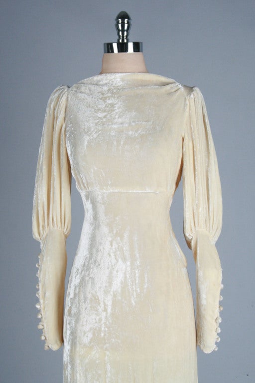 vintage 1930's wedding dress 

* ivory/champagne silk velvet
* small train pools in back (ring has been added for storage/hanging purposes)
* snaps on side
* juliette sleeves with covered buttons
* bias cut
* empire waist

condition | tiny