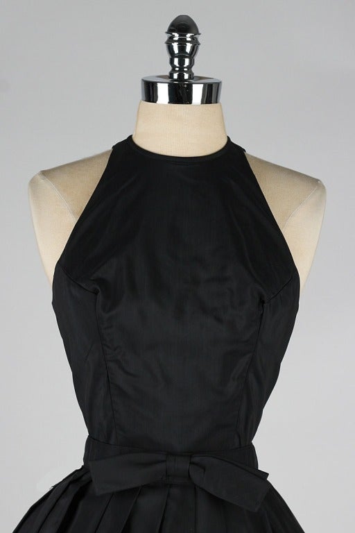 vintage 1950's dress

* black silk taffeta
* halter style with keyhole opening in back
* full skirt
* cotton and tulle linings
* detachable bow belt
* metal back zipper
* by Suzy Perette

condition | excellent - bit of fading on bodice
