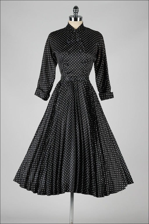 vintage 1950's dress

* black white polka dot acetate
* acetate lining
* metal side zipper
* front button closure
* detachable belt
* full knife pleat skirt
* by Suzy Perette

condition | excellent

fits like xs

length 47