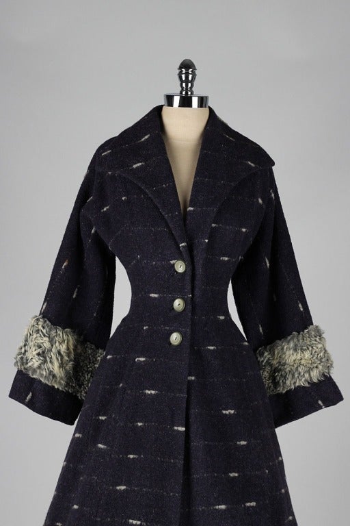 vintage 1950's coat

* dark blue wool with white stitching details
* fur trim cuffes
* fitted waist with full skirt
* acetate lining
* by Lilli Ann

condition | excellent

fits like m/l

length 42