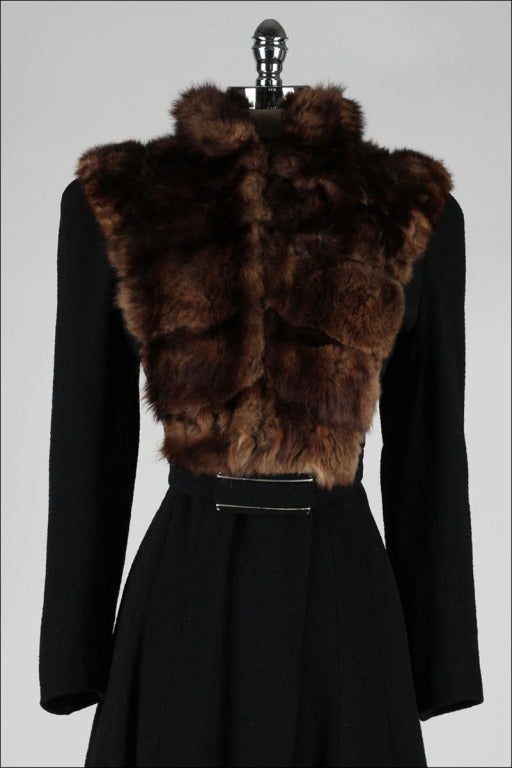 vintage 1940's coat

* black wool boucle
* mink fur bib
* attached belt
* satin lining

condition | excellent - just a bit of wear at edges of belt buckle

fits like medium

length 44