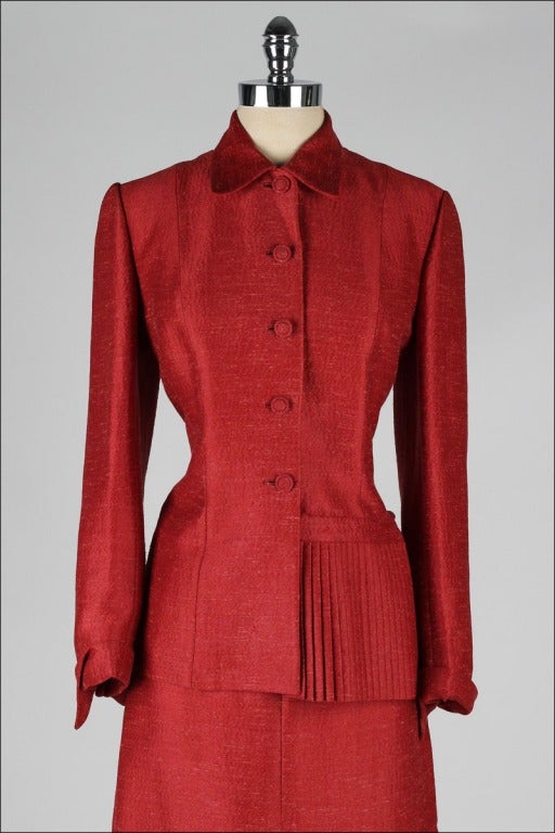 vintage 1950's suit

* cranberry red silk blend
* pleated details
* acetate lined jacket
* metal side zipper skirt
* by Lilli Ann

condition | excellent

fits like medium

jacket:
length 25