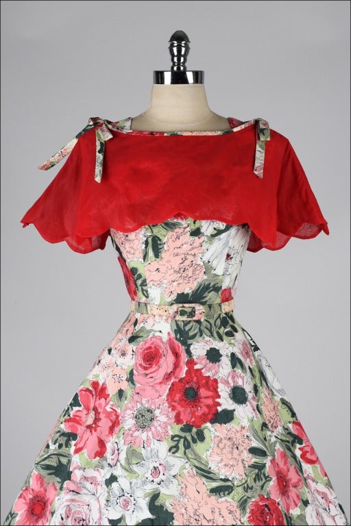 1950's dress and caplet

* floral print polished cotton
* studded with rhinestones
* metal back zipper
* matching belt
* full skirt
* chiffon caplet with shoulder ties
* by Shayne of Miami

condition | excellent

fits like xs/s

length