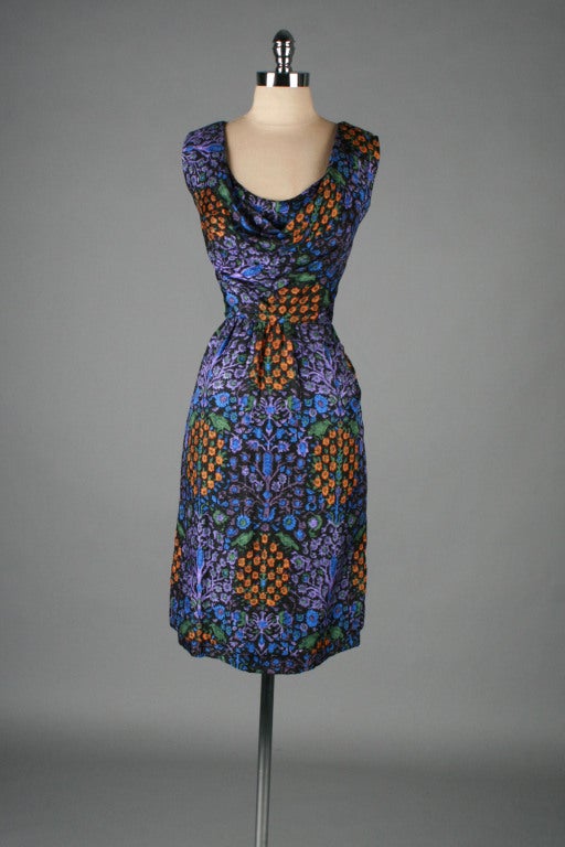 vintage 1950's dress

* purple silk
* silk lining
* tapestry print
* swag draped neckline
* metal back zippers on lining and exterior
* by Guy Laroche

condition | excellent

fits like size large

length 41
