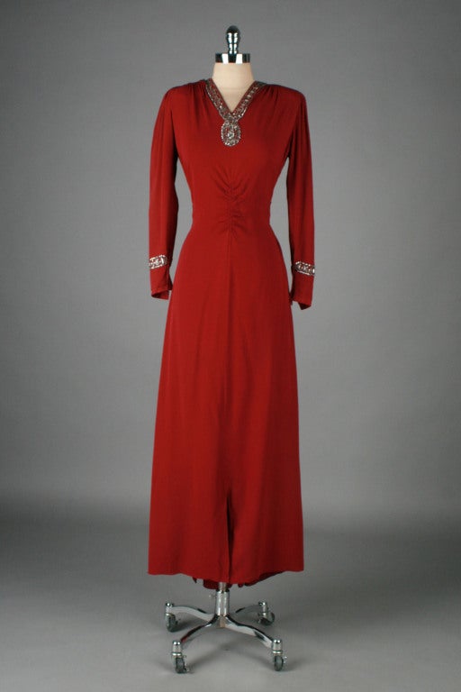 vintage 1940's dress

* cranberry red rayon crepe
* beautiful rhinestone details
* attached tie belt
* front hem slit
* metal side zipper
* from Hana Lee Louisville, KY

condition | excellent

fits like medium

length 59