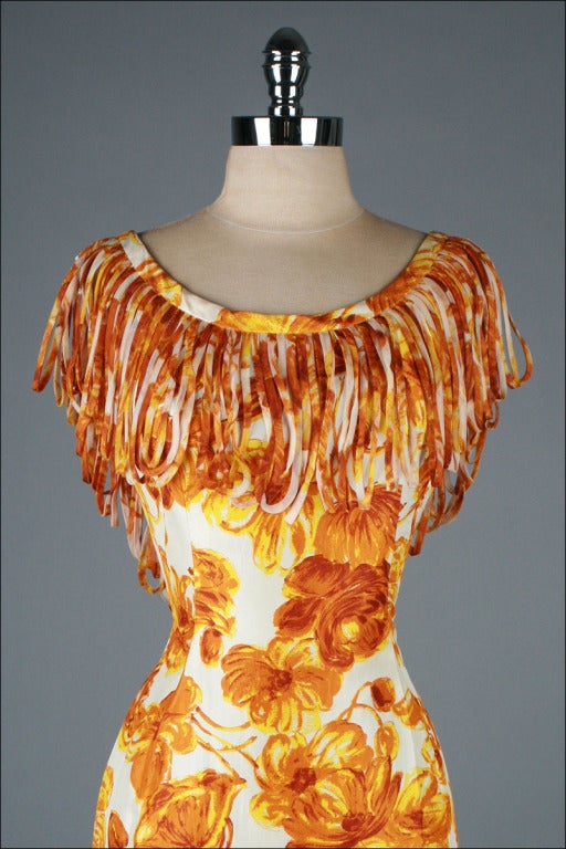 vintage 1950's dress

* orange floral silk
* acetate lining
* looped fringe chiffon collar
* metal back zipper
* by Anita Modes