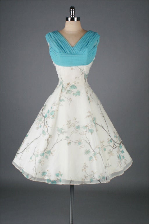 vintage 1950's dress

* white and sky blue chiffon
* beautiful metallic bird print
* acetate lining
* full skirt
* metal back zipper

condition | excellent

fits like medium

length 42
