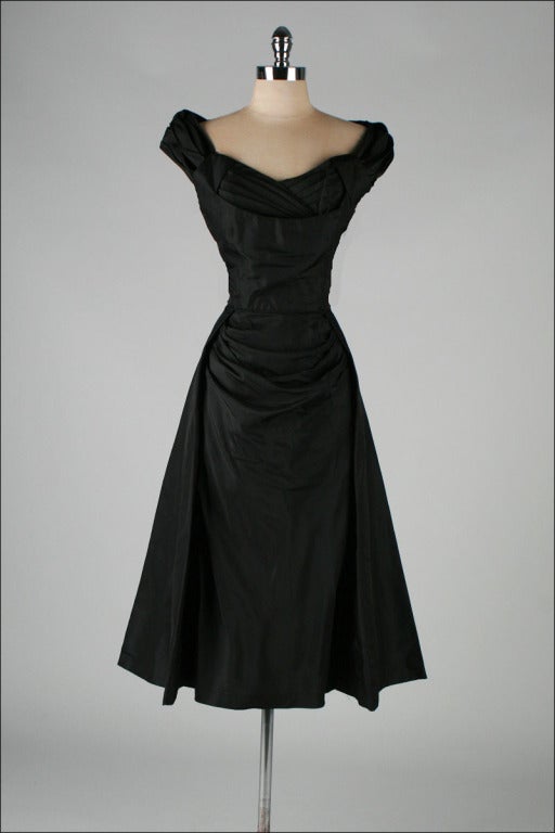 vintage 1950's dress

* black silk taffeta
* gorgeous ruche details
* full skirt with fabulous front draping
* acetate and pellon linings
* metal back zipper
* by Miss Kane

condition | excellent

fits like medium

length 50