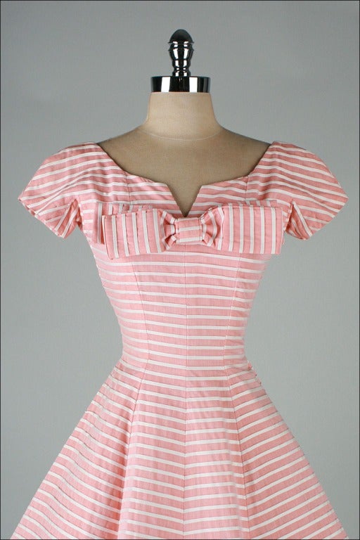 vintage 1950's dress

* pink midweight woven cotton 
* white striped details
* muslin lined skirt
* metal back zipper
* by Suzy Perette

condition | excellent

fits like xs/s

length 44