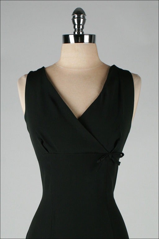 vintage 1950's dress

* black silk/rayon blend
* cross over bust with little bow
* offset metal zipper
* by Pierre Balmain

condition | excellent

fits like medium

length 44