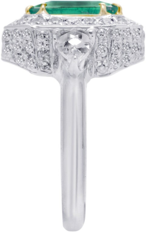 Ring set in 18k White & Yellow Gold. One, 3.42 carat Emerald. 1.85 carats of round-cut Diamonds.