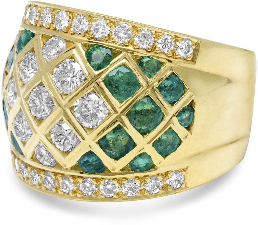 Set in 18k yellow gold these emeralds and diamonds are set in a beautiful pattern.  The ring was designed to be subtle in style and still grab lots of attention.