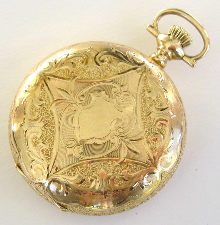 The movement is marked Elgin National Watch Co, serial number 16654345, 15 jewels, and dates to 1911 according to the serial number.
 
Has an outstanding 14k yellow gold ornate box-hinge case with image of a home, on the opposite side is an shield