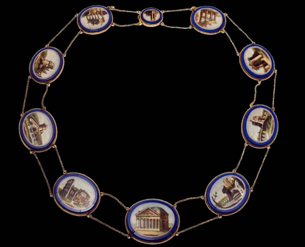 A Yellow gold necklace composed of ten micromosaic plaques on blue glass-paste and double chain. The plaques depict the views of ancient Rome and its surroundings, such as: Pantheon, Coliseum, Ponte Lucano, the tomb of Cecilia Metella, the Temple of