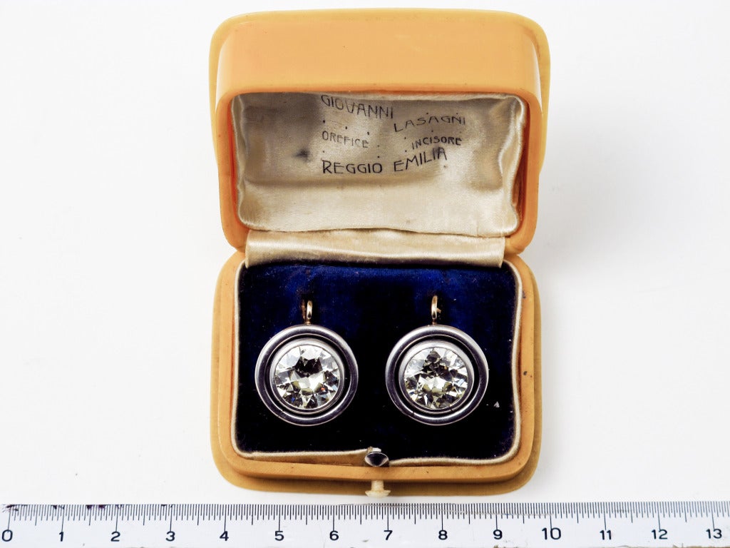 A pair of Belle Epoque platinum and gold earrings with two old-cut diamonds weighting 9,2 carats c.a. total. colour L-M, clarity VVS2. In Original Bakelite Box. With the original invoices.