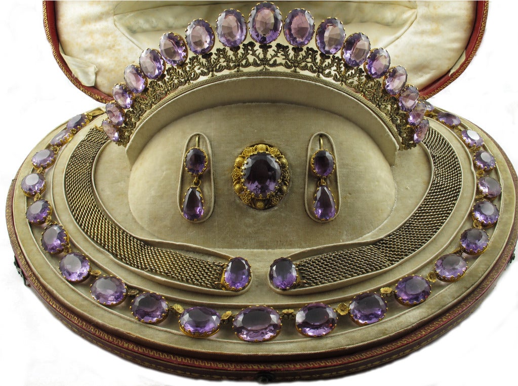 A yellow gold and amethyst parure composed of one necklace, two bracelets, one brooch, a tiara and a pair of earrings. France, around 1820. In original leather box bearing the word 