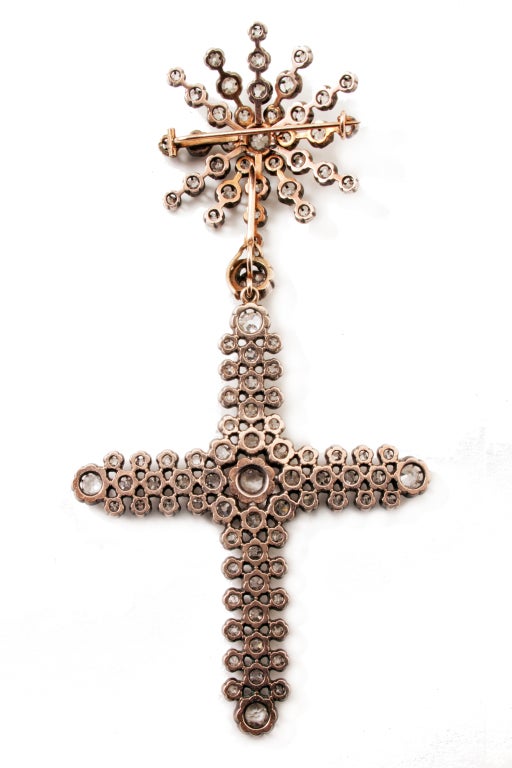 A late victorian convertible cross-pendant hanging from a star brooch.