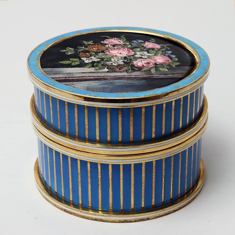 A wonderful round striped box , one of a kind  edition signed Laura G  Art with Heart, enamelled in turquoise and gold  stripes on silver gold plated , miniature handpainted with  flowers on the top , pink roses and field flowers on a balcony ,