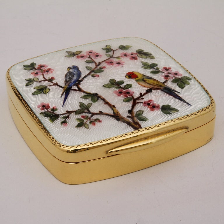 Amazing silver goldplated little box with miniature of parrots on fiori di pesco, handpainted on guillochè and mother of pearl fired enamel. The shape is square ,  rounded on the corners, just a rare example of Art with Heart, a little jewel for