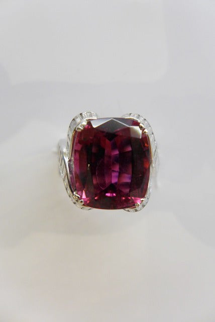 Platinum ring set with a rubellite and baguette-cut diamonds