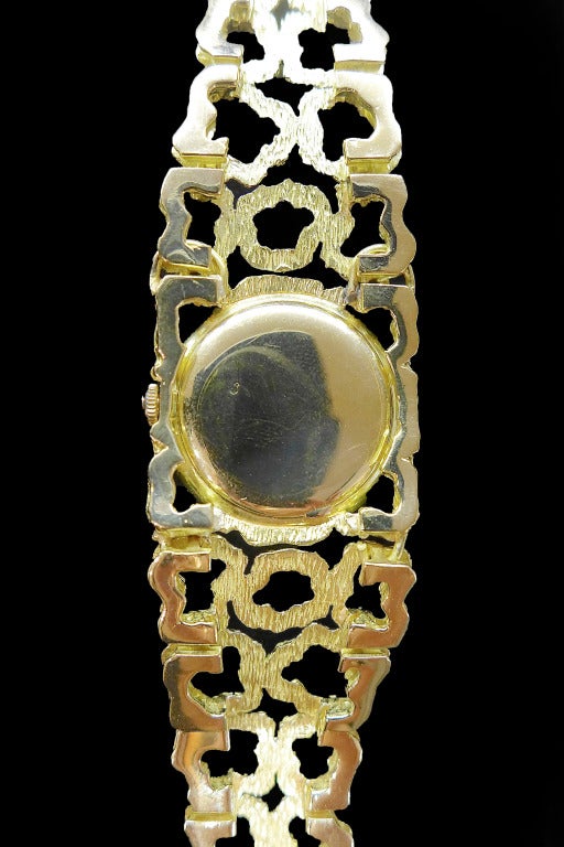 An 18k yellow gold Omega lady's bracelet watch with diamond bezel. Designed by Swiss jeweler Gilbert Albert. Self-winding movement. Circa 1970. Length, 190 mm.