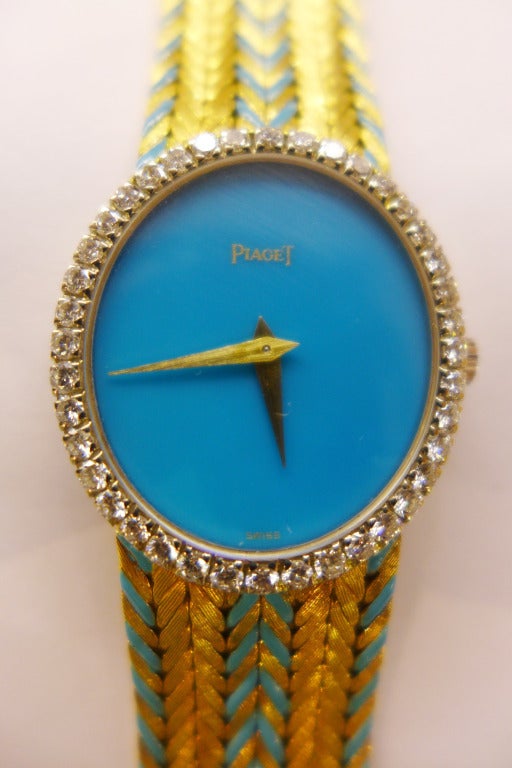 Piaget 18k yellow gold lady's bracelet watch.
Turquoise dial surrounded by a bezel of diamonds. The flat bracelet is made with gold 