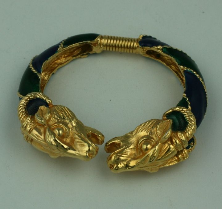 Rams head spring action bracelet from Donald Stannard, 1960s. Enamelled in navy and forest green to highlight gilt ram's heads terminals.American 1960s. Size: small<br />
interior 2.25