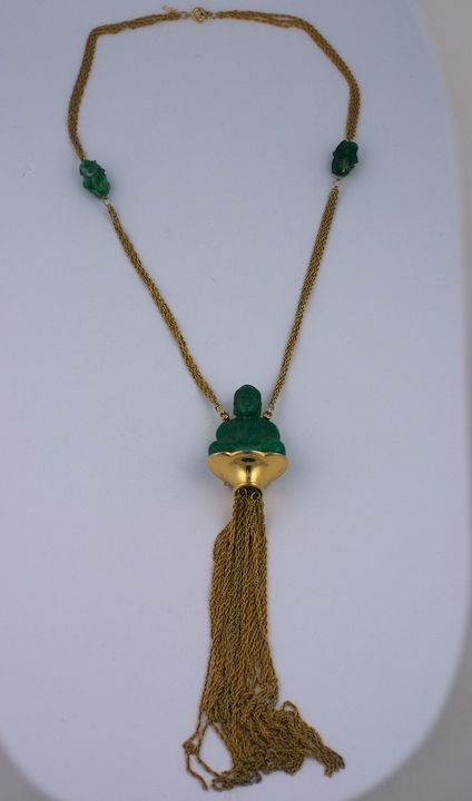 Trifari faux jade buddha pendant with massive chain tassel. Buddha figure sits on golden plinth with long tassel below.<br />
Faux jade beads on neck chain as well. 1960s USA.<br />
Excellent condition.