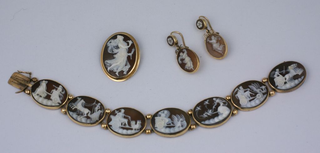 Victorian shell cameo suite from the late 19th Century, Set in 14K gold, the cameos represent mythological figures in different scenes. Suite includes brooch, pierced earrings and scenic bracelet. Intricately hand carved quality cameos.
Excellent