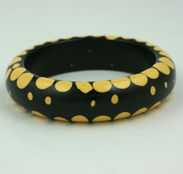 Wonderful, rare injection dot bracelet by Belle Kogan, circa 1930s. Random dots bracelet of cream on black bakelite base.<br /> Interior measurement 8
