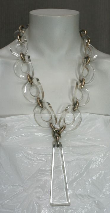 Striking lucite and chrome necklace from the 1960s USA.<br />
Curved discs of lucite wrap comfortably around neck. Hook closure on back.  Adjustable 18-24