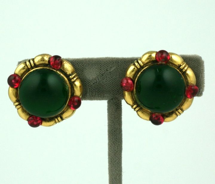 Chanel clip earrings with large faux emerald cabochon surrounded by 4 ruby cabochons in a gilt metal setting.
1