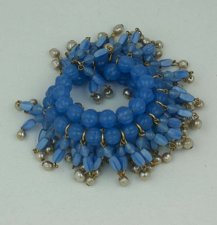 Rare Miriam Haskell flexiable wrap bracelet of cornflower blue pate de verre mellon beads,round and petal shape beads, ending with baroque pearls.