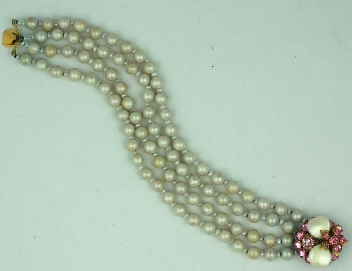 Miriam Haskell four strand  freshwater pearl bracelet. The ornate clasp is decorated of fresh water pearl petals and pink diamante stones and flower heads.<br />
Excellent condition. 1950s.