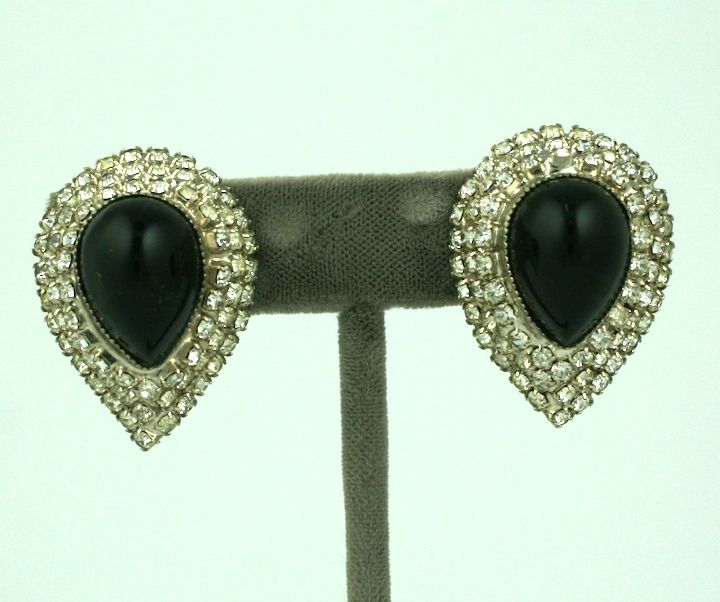 Attractive cabochon black pear shaped glass earrings with a pave rhinestone surround. BY William De Lillo, 1960s USA.<br />
Excellent condition. Clip back fittings. 1.25