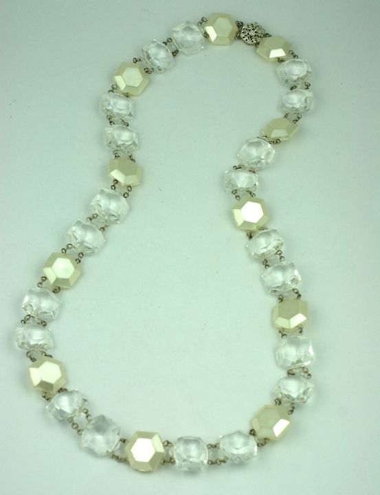 Striking Miriam Haskell necklace of linked pearl and clear lucite chandelier crystal stations. Signed on clasp.<br />
32