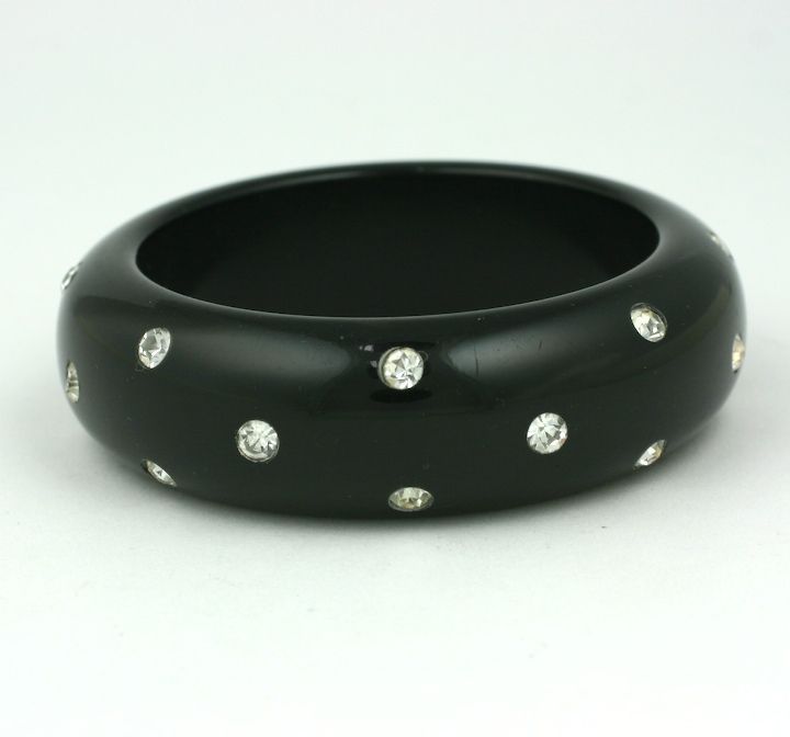 Chunky black bakelite bangle bracelet from the 1950's set throuhgout with crystal rhinestones. <br />
Diameter interior 2.5