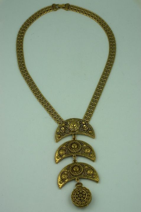 Unusual etruscan style articulated pendant with hidden locket. Antique gold finish. USA 1970s.
20