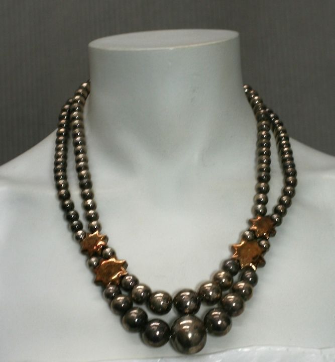 Unusual necklace composed of hollow sterling beads with rose gold washed 