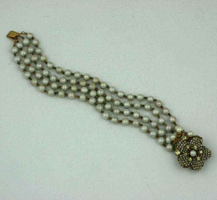 Miriam Haskell four strand fresh water bracelet. the floral clasp of pave seed pearls, and citrine crystal stamens.
7.5